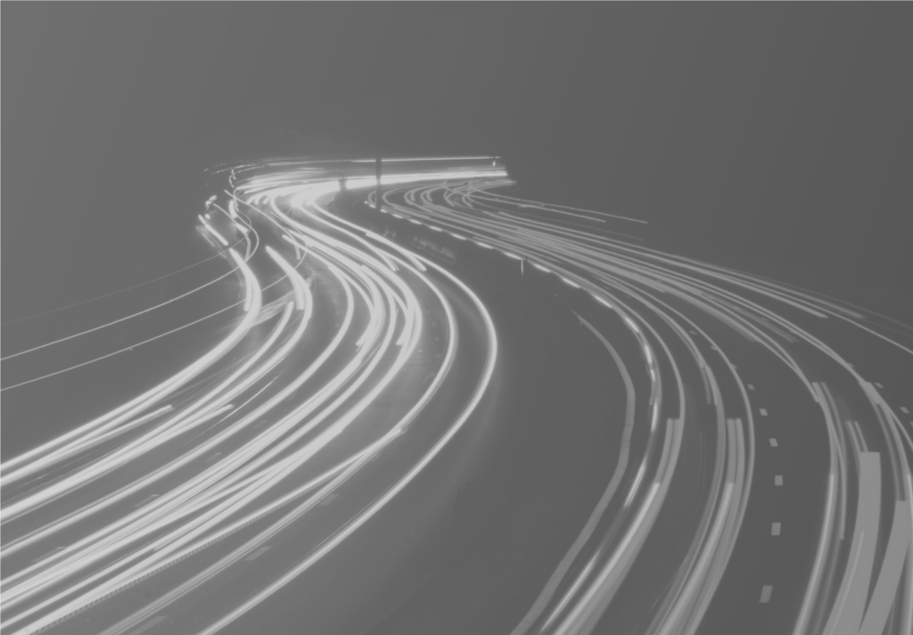 A busy motorway with high exposure care lights to creates lines across the road.
