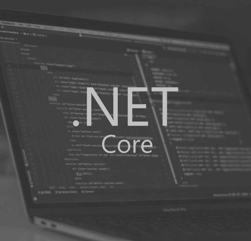 .Net Core logo with a laptop in the background.