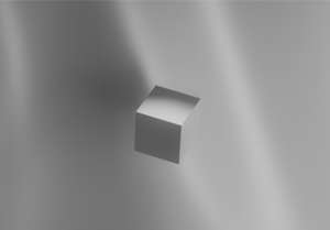A greyscale cube on top of a grey background.